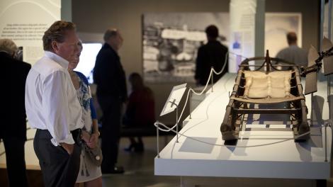 Visitors inspecting a display at the exhibition Traversing Antarctica